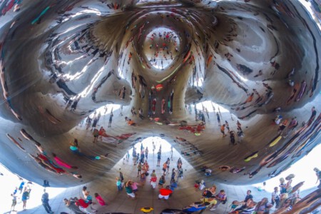 Cloud Gate is a public sculpture by Indian-born British artist Anish Kapoor, that is the centerpiece of AT&T Plaza at Millennium Park in the Loop community area of Chicago, Illinois. The sculpture and AT&T Plaza are located on top of Park Grill. Constructed between 2004 and 2006, the sculpture is nicknamed The Bean because of its legume-like shape. Made up of 168 stainless steel plates welded together, its highly polished exterior has no visible seams.