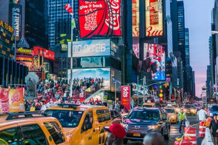 Times Square is a major commercial intersection and neighborhood in Midtown Manhattan, New York City. Brightly adorned with billboards and advertisements, Times Square is sometimes referred to as The Crossroads of the World, The Center of the Universe and the heart of The Great White Way. Times Square is one of the world's most visited tourist attractions, drawing an estimated fifty million visitors annually.